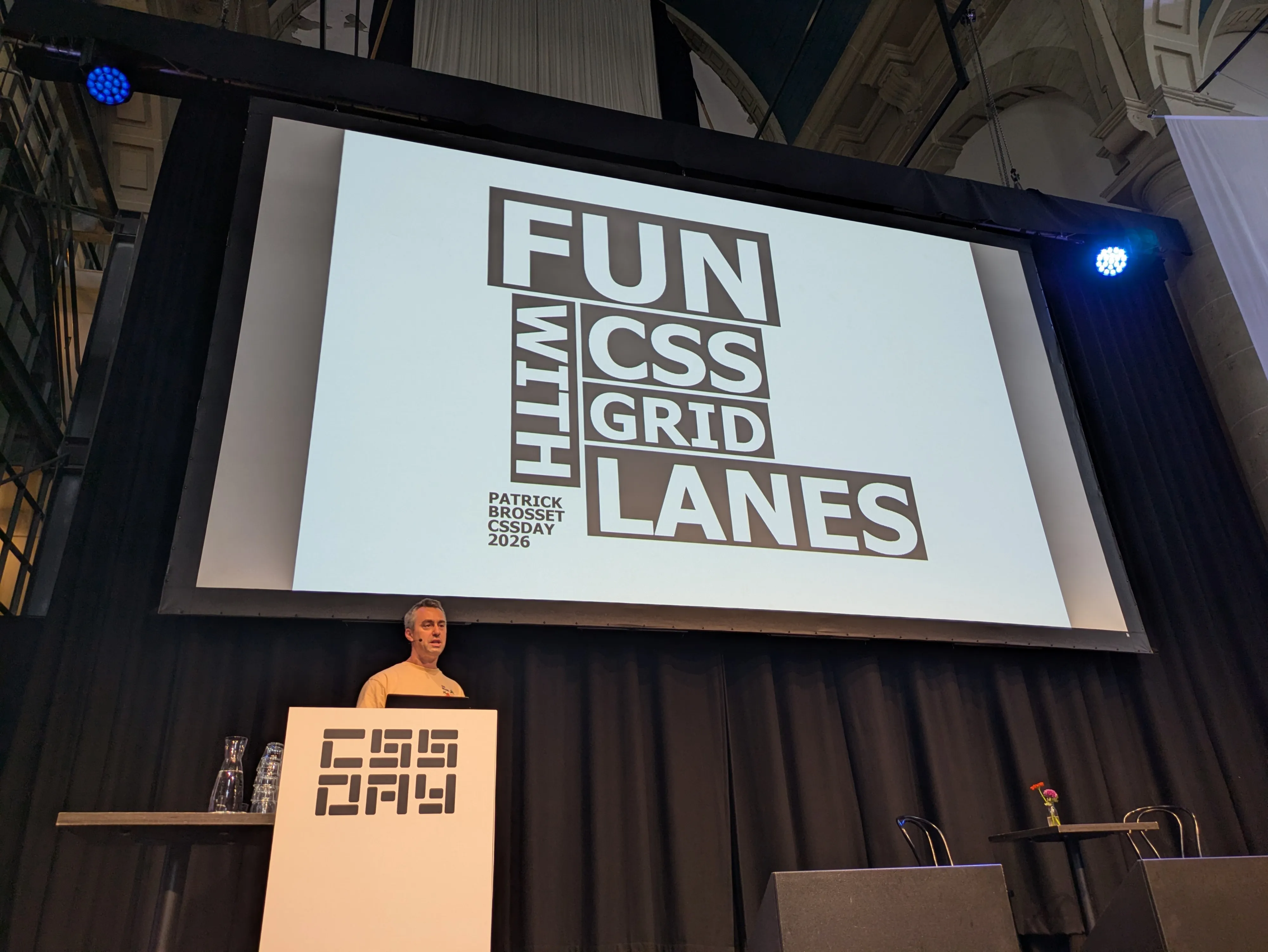 Me, on stage, at CSS Day, with the intro slides behind me, saying Fun with CSS Grid Lanes.